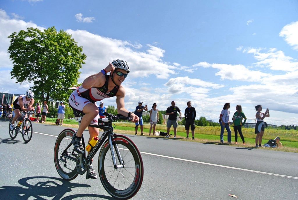 Happy athlete on the second leg of the triathlon - the bike leg.