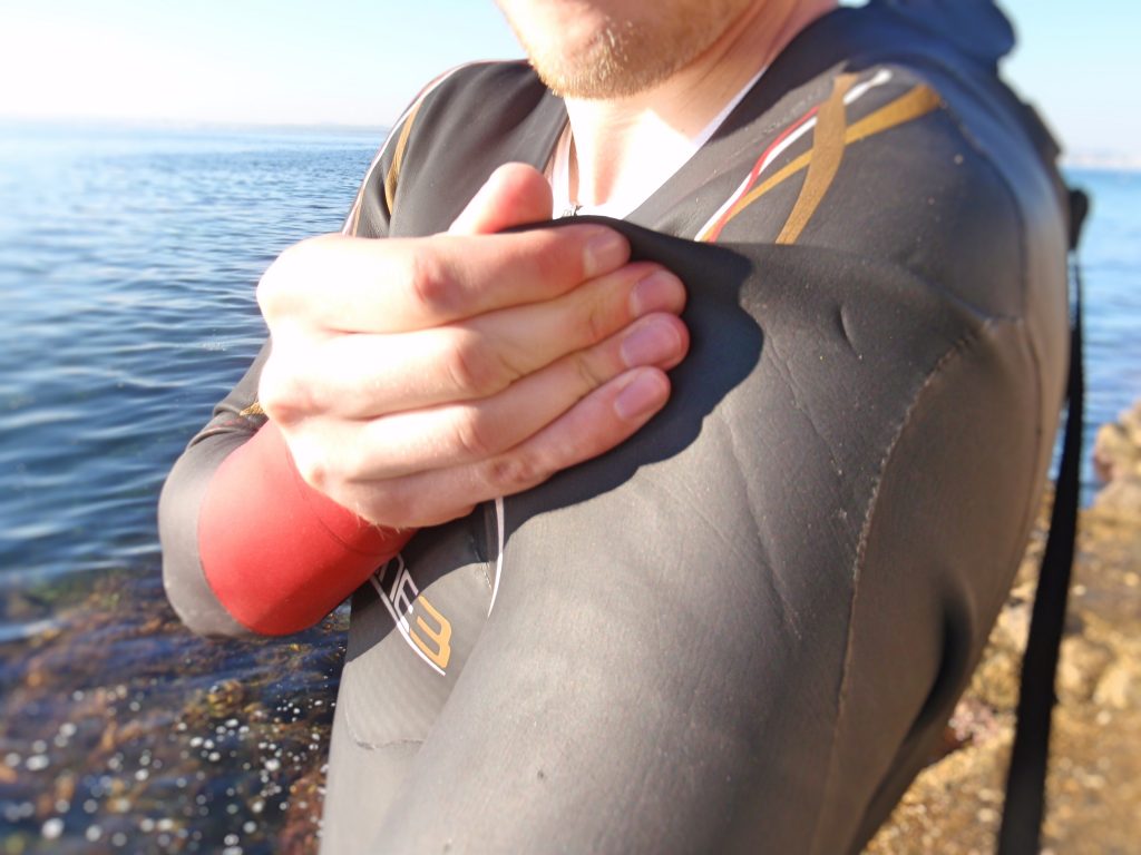 Putting on a wetsuit on upper body